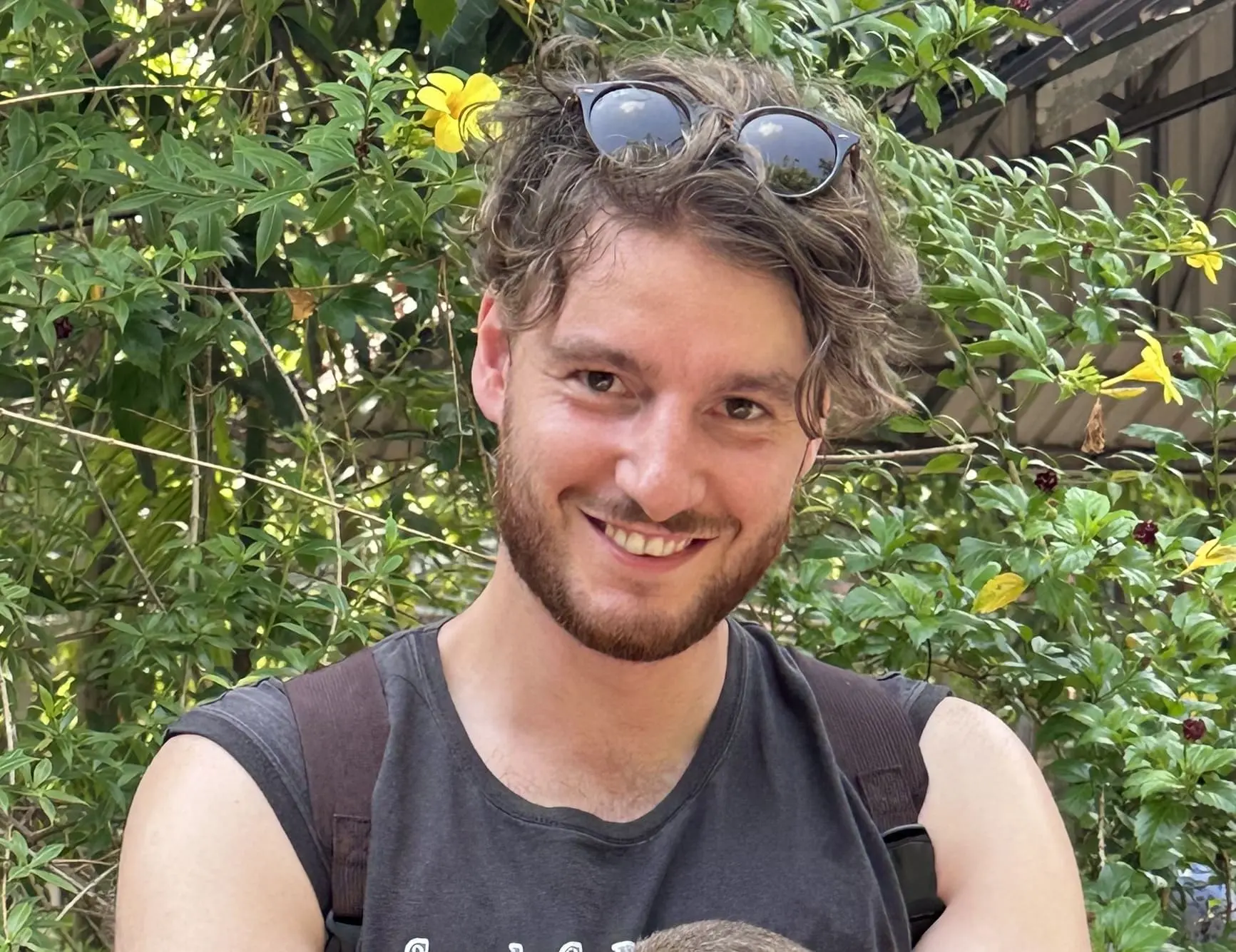 Davide smiling while holding a rat