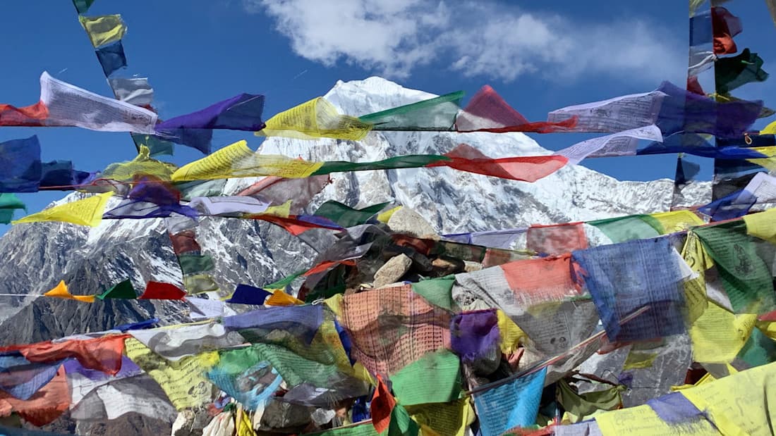 Prayer flags on Kyanjin Ri Colours and snowy peaks