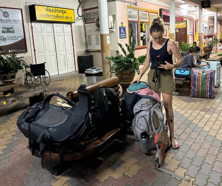 Bea at Chumphon Station Bea looking at her broken camera lens, with all our baggage while we wait for the sleeper train from Chumphon Station to Hat Yai.